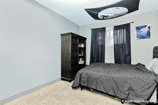 bedroom with lofted ceiling and a textured ceiling