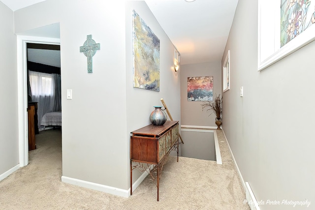 hall with light carpet and a wealth of natural light