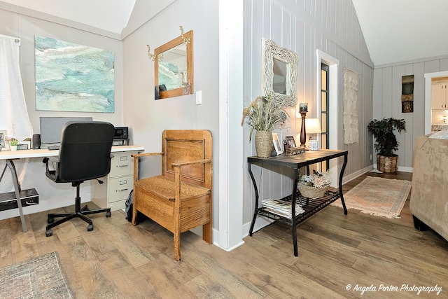 office space with light hardwood / wood-style floors and vaulted ceiling