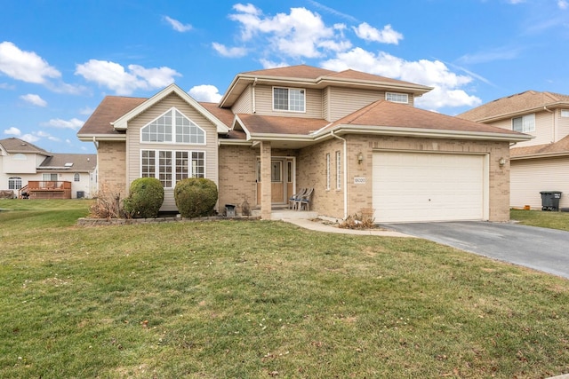 view of front of home with a front yard and a garage