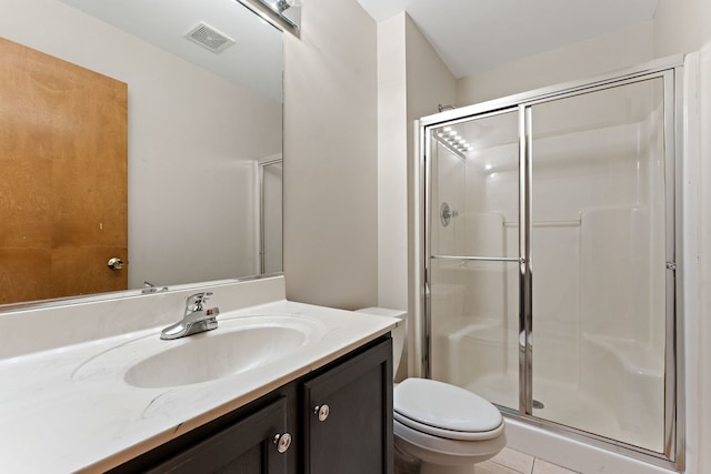 bathroom featuring tile patterned floors, vanity, toilet, and walk in shower