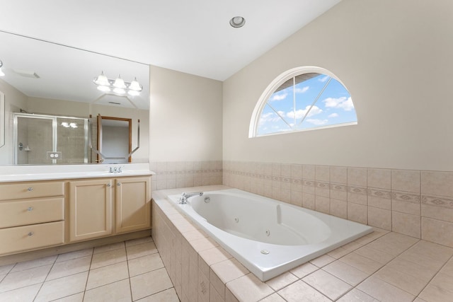 bathroom featuring tile patterned floors, vanity, vaulted ceiling, and shower with separate bathtub