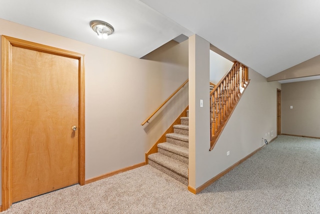 stairs featuring carpet flooring