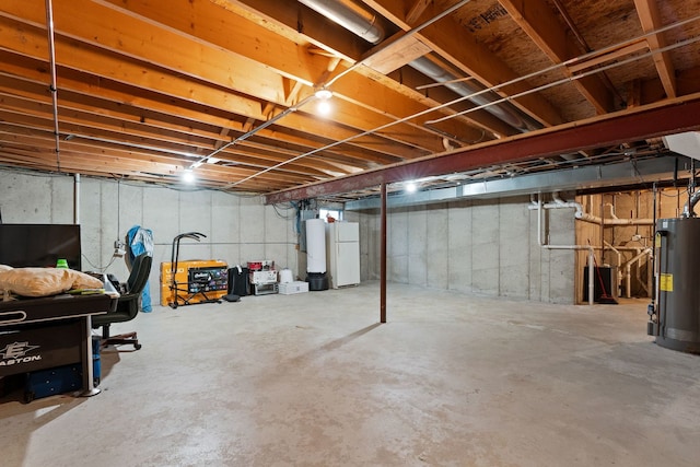 basement featuring gas water heater and white refrigerator