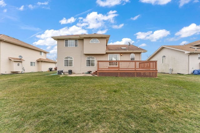 back of house featuring a patio, a yard, and a deck