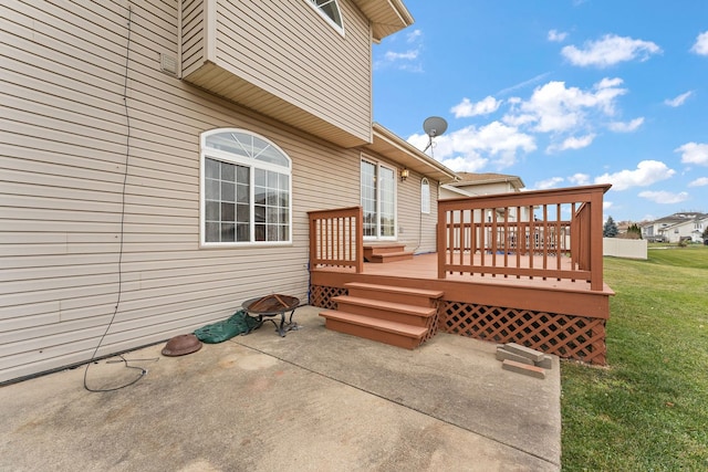 wooden terrace with a patio area and a yard