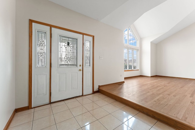 foyer entrance featuring light hardwood / wood-style floors and vaulted ceiling