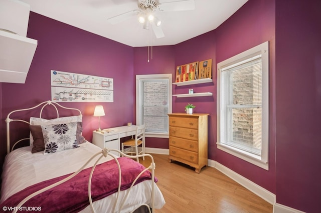 bedroom featuring wood finished floors, baseboards, and ceiling fan