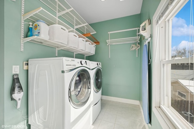 laundry area featuring laundry area, separate washer and dryer, baseboards, and tile patterned floors