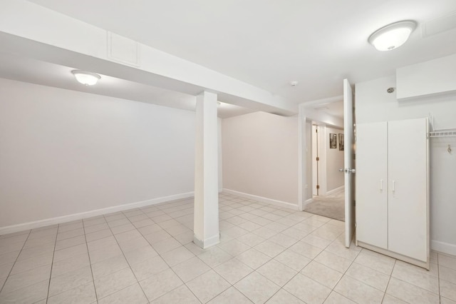 finished basement featuring light tile patterned floors and baseboards