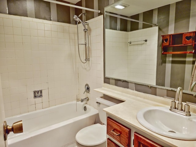 full bathroom with vanity, toilet, and tiled shower / bath