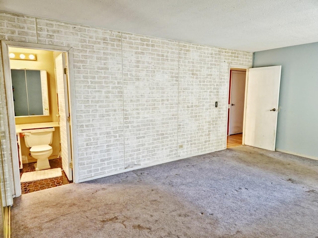 carpeted spare room with a textured ceiling