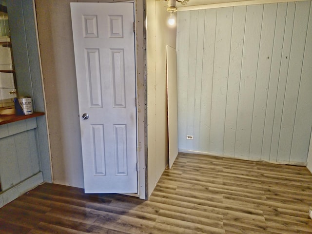 hallway with dark hardwood / wood-style flooring