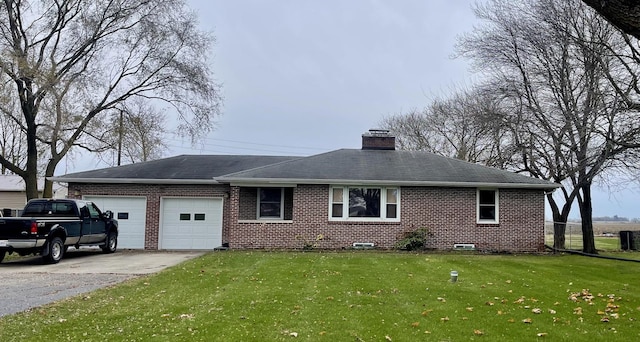 view of front of house with cooling unit, a front yard, and a garage