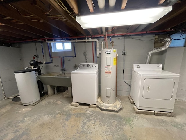 basement featuring sink, electric water heater, and washing machine and clothes dryer