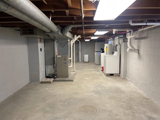 basement with gas water heater, washer / clothes dryer, and heating unit