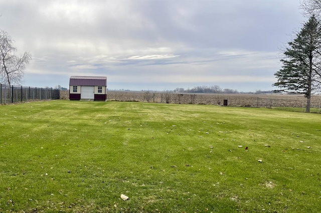 view of yard with a rural view and an outdoor structure