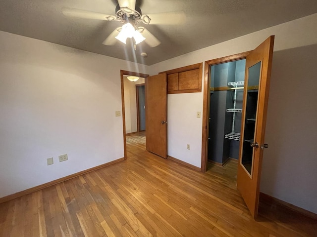 unfurnished bedroom with light wood-type flooring and ceiling fan