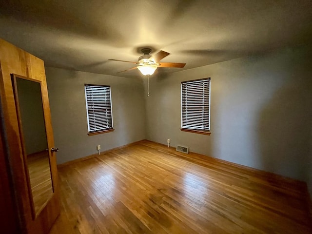 unfurnished bedroom featuring hardwood / wood-style flooring and ceiling fan