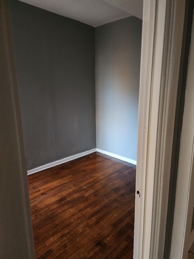 spare room with dark hardwood / wood-style flooring