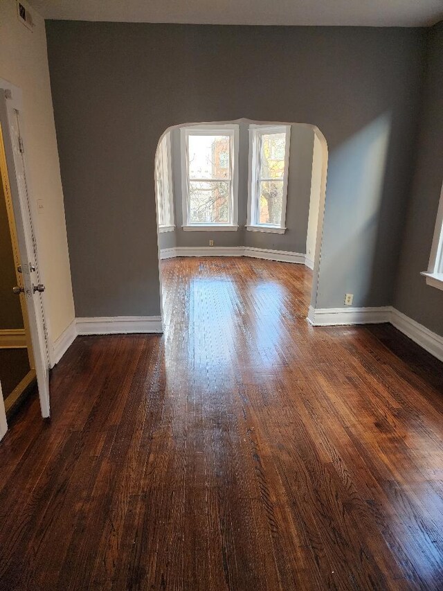 spare room featuring dark wood-type flooring