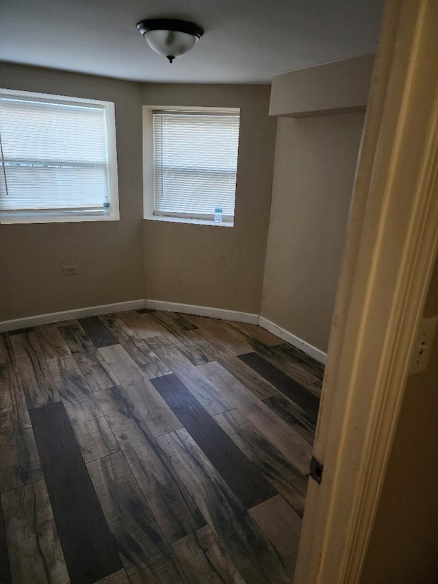 unfurnished room with dark hardwood / wood-style floors