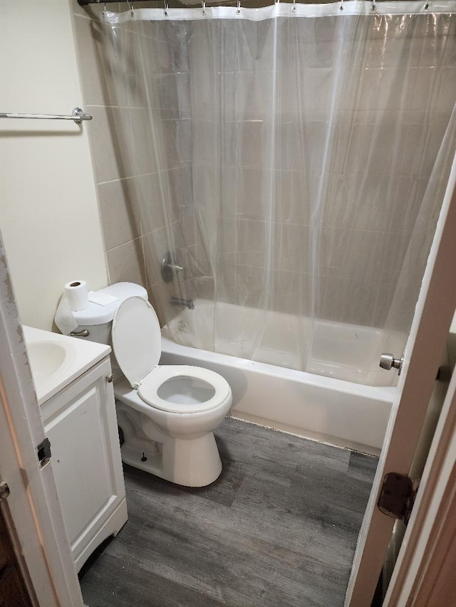 full bathroom with hardwood / wood-style flooring, vanity, toilet, and shower / bath combo