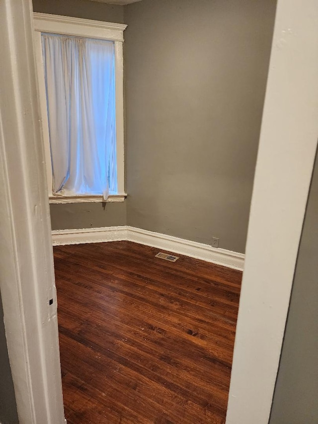 spare room with hardwood / wood-style floors