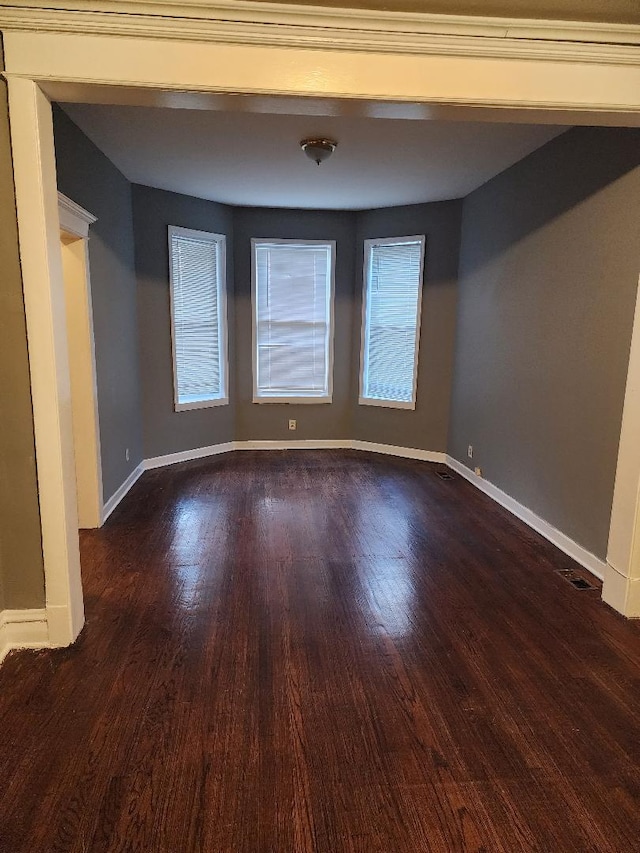 empty room featuring dark wood-type flooring