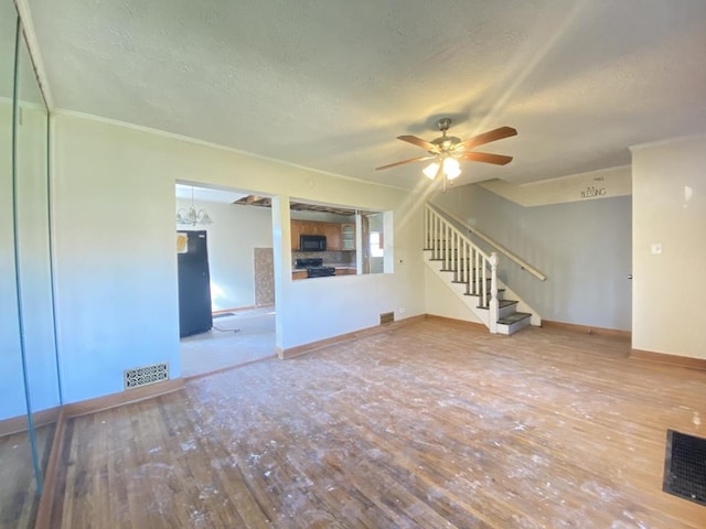 unfurnished living room with hardwood / wood-style floors, ceiling fan, ornamental molding, and a textured ceiling