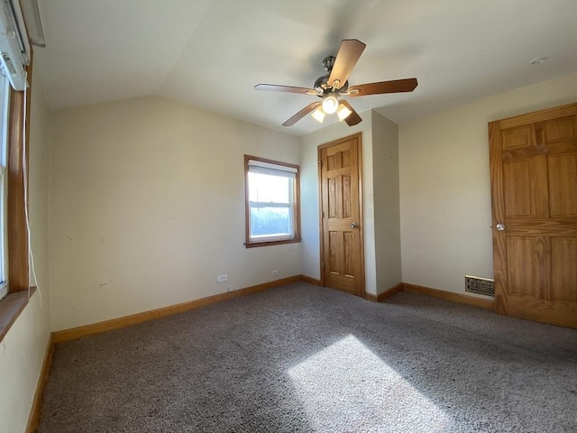 unfurnished bedroom featuring ceiling fan, lofted ceiling, and carpet floors