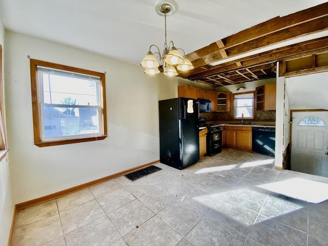 kitchen with backsplash, black appliances, pendant lighting, light tile patterned floors, and an inviting chandelier