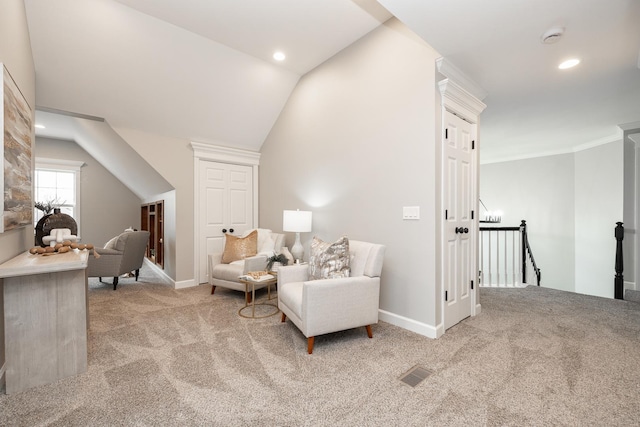 living area featuring light colored carpet and vaulted ceiling