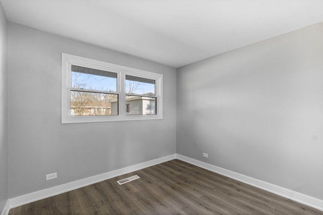 spare room with dark hardwood / wood-style floors