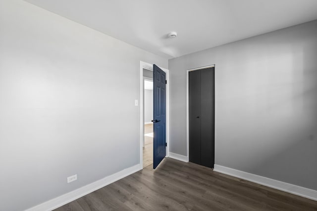 spare room with dark hardwood / wood-style floors