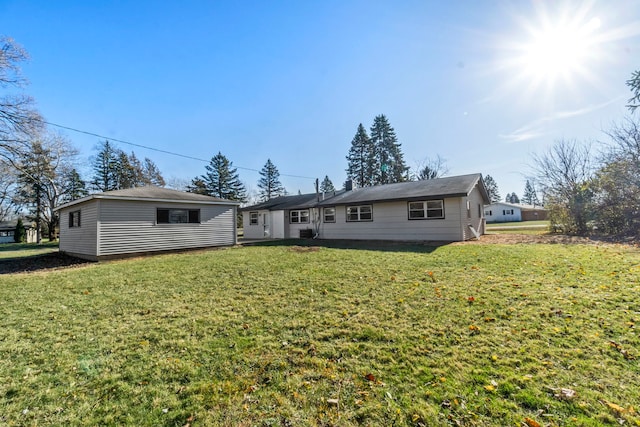 back of property featuring a lawn