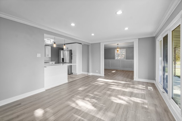 unfurnished living room with light hardwood / wood-style flooring and ornamental molding