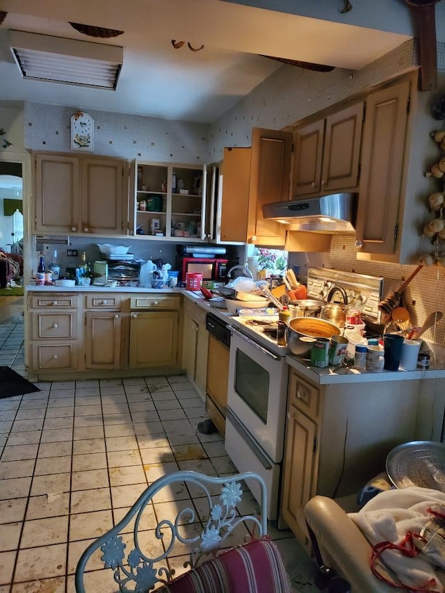 kitchen with light brown cabinets, white appliances, and light tile patterned flooring