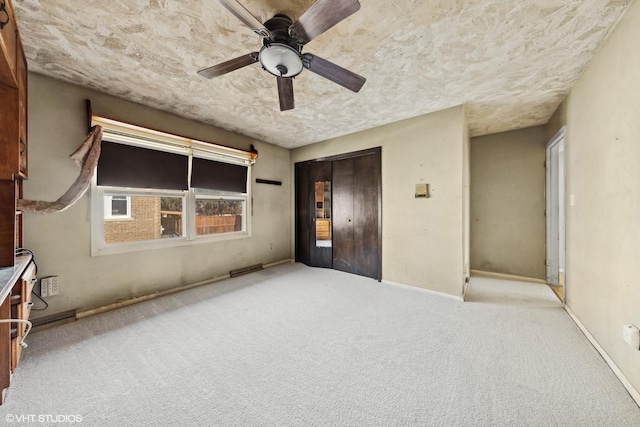 unfurnished bedroom with ceiling fan, a closet, light carpet, and elevator