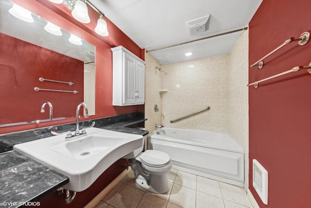 full bathroom featuring toilet, tiled shower / bath combo, tile patterned flooring, and sink