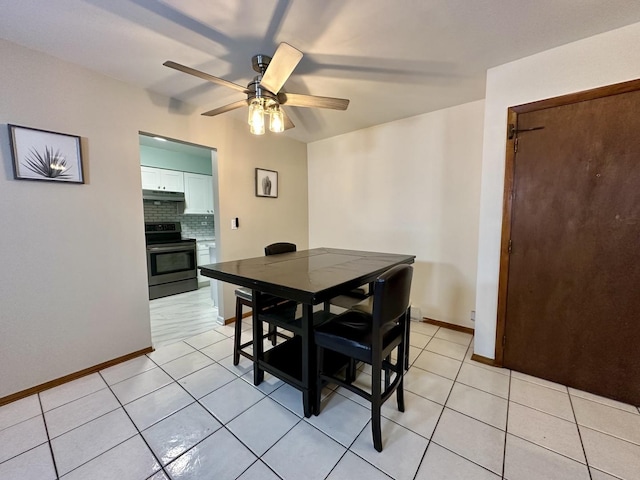 tiled dining area featuring ceiling fan