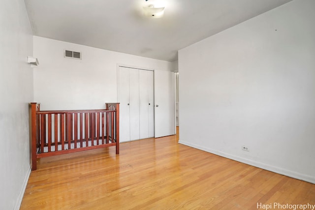 bedroom featuring wood-type flooring and a closet