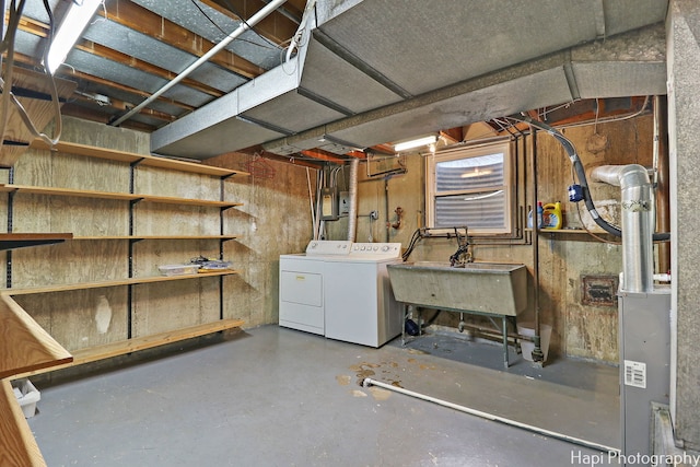 basement with separate washer and dryer and sink