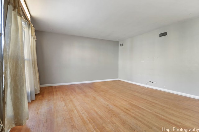 spare room featuring light hardwood / wood-style floors