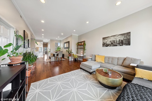 living area with ornamental molding, wood finished floors, and recessed lighting