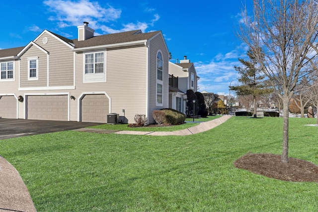 view of property exterior with a garage and a yard