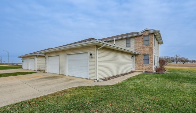 view of side of home with a garage and a lawn