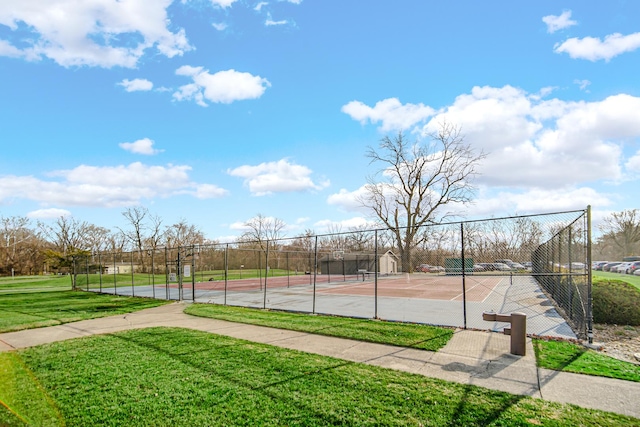 view of sport court with a lawn