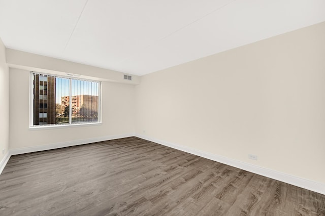 spare room with hardwood / wood-style flooring