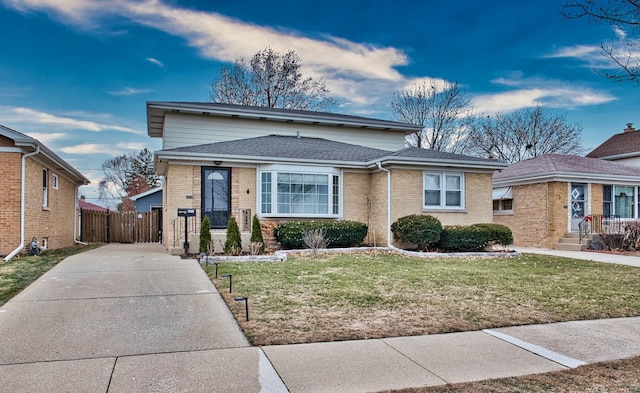 bungalow-style home with a front lawn